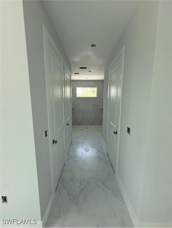 3722 29th Ave NE, Naples, FL 34120 - corridor featuring light marble finish flooring and baseboards