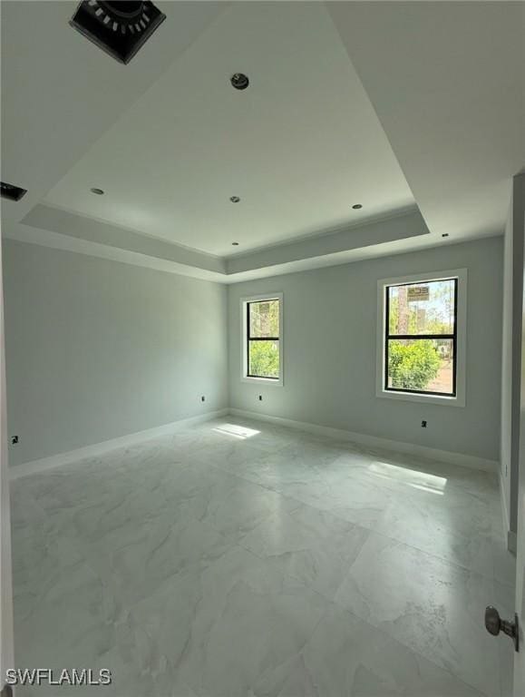3722 29th Ave NE, Naples, FL 34120 - empty room with a tray ceiling and marble look tile flooring