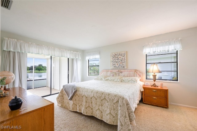 113 Picardy Ct, Naples, FL 34112 - carpeted bedroom featuring access to exterior and a water view