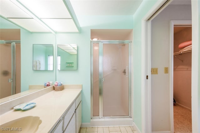 113 Picardy Ct, Naples, FL 34112 - bathroom featuring vanity, a shower stall, and a spacious closet