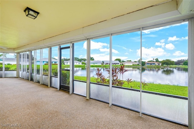 113 Picardy Ct, Naples, FL 34112 - unfurnished sunroom featuring a water view and plenty of natural light