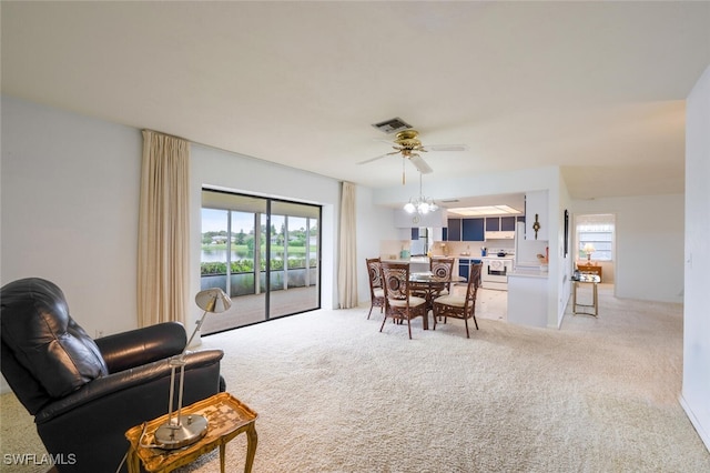 113 Picardy Ct, Naples, FL 34112 - living area with light carpet, ceiling fan, and a water view