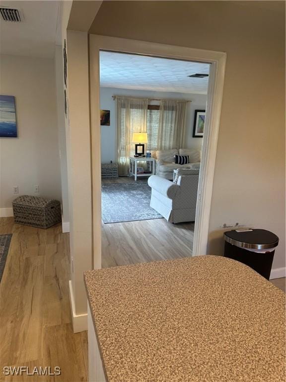 120 Bay Mar Dr, Fort Myers Beach, FL 33931 - hall featuring light wood-style flooring and baseboards