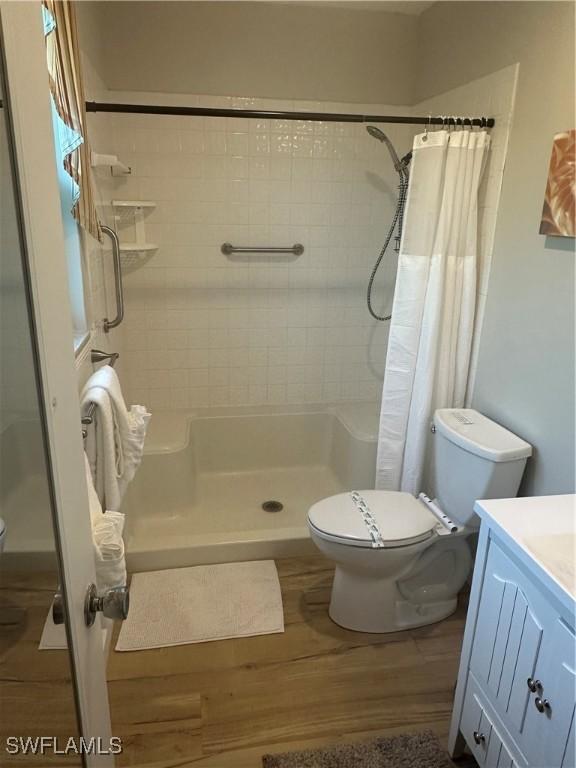 120 Bay Mar Dr, Fort Myers Beach, FL 33931 - bathroom with wood finished floors, vanity, and a shower stall