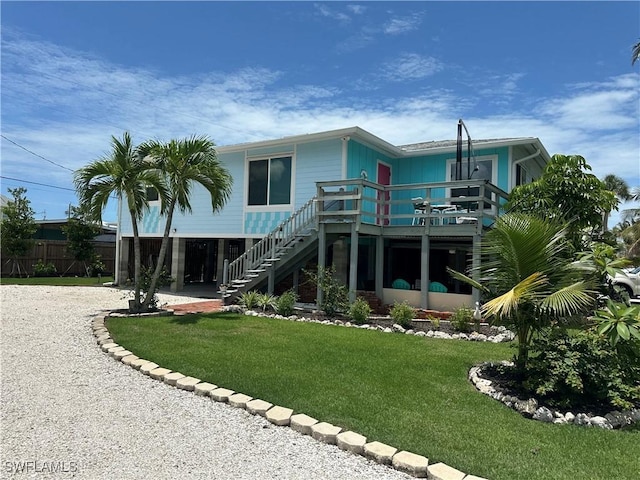 120 Bay Mar Dr, Fort Myers Beach, FL 33931 - back of property with stairs, gravel driveway, and a deck