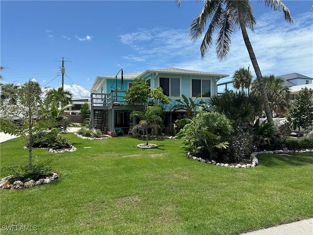 120 Bay Mar Dr, Fort Myers Beach, FL 33931 - view of green lawn featuring stairway and a wooden deck