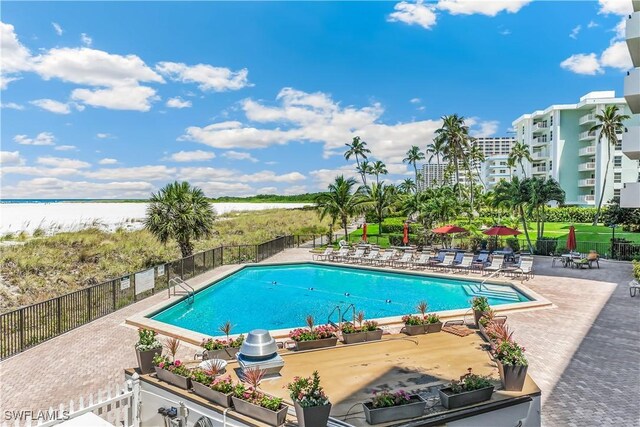 180 Seaview Ct Unit 507, Marco Island, FL 34145 - community pool featuring a patio area and a water view