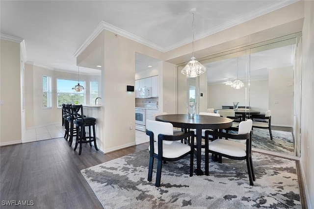 8610 Cedar Hammock Cir Unit 1223, Naples, FL 34112 - dining room with a chandelier, wood finished floors, and crown molding