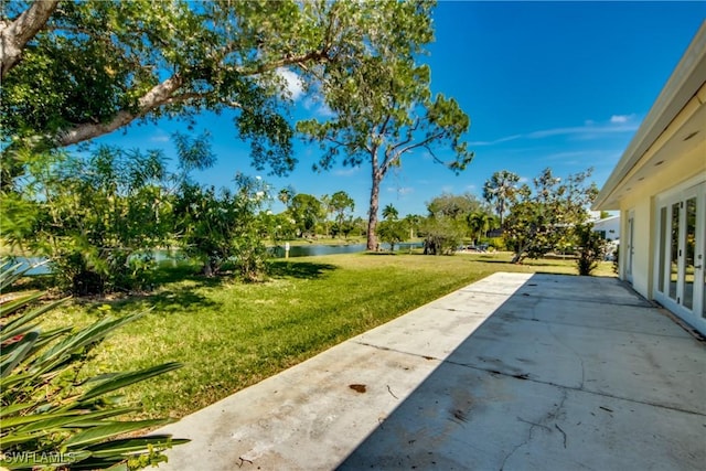 17225 Castleview Dr, North Fort Myers, FL 33917 - view of green lawn featuring a water view and a patio area