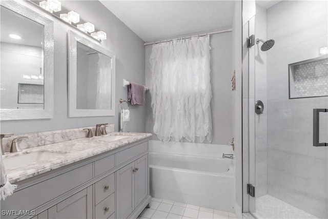 6770 Huntington Lakes Cir Unit 203, Naples, FL 34119 - full bath with a shower stall, a garden tub, double vanity, and tile patterned floors