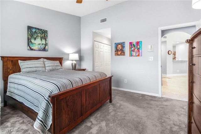 6770 Huntington Lakes Cir Unit 203, Naples, FL 34119 - bedroom featuring carpet floors, a closet, arched walkways, and ceiling fan