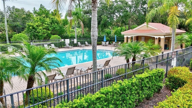 6770 Huntington Lakes Cir Unit 203, Naples, FL 34119 - community pool with a patio area and view of scattered trees