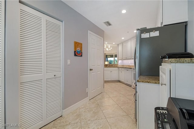 6770 Huntington Lakes Cir Unit 203, Naples, FL 34119 - kitchen with white cabinetry, light tile patterned flooring, and recessed lighting
