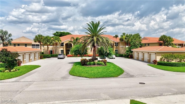 6770 Huntington Lakes Cir Unit 203, Naples, FL 34119 - mediterranean / spanish home with a residential view, driveway, and community garages