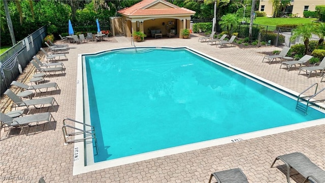 6770 Huntington Lakes Cir Unit 203, Naples, FL 34119 - community pool featuring a patio