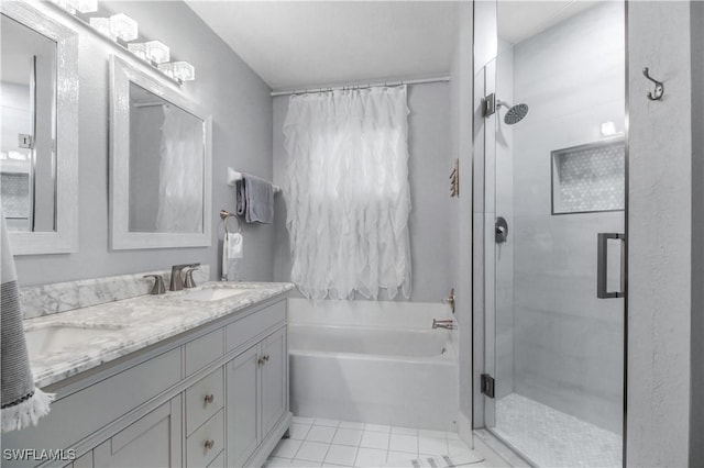 6770 Huntington Lakes Cir Unit 203, Naples, FL 34119 - bathroom with a shower stall, a garden tub, double vanity, and tile patterned floors