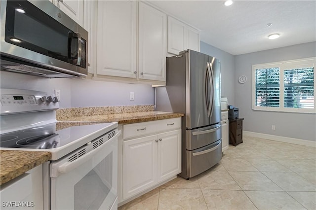 6770 Huntington Lakes Cir Unit 203, Naples, FL 34119 - kitchen featuring stainless steel appliances, white cabinets, light tile patterned floors, and light countertops