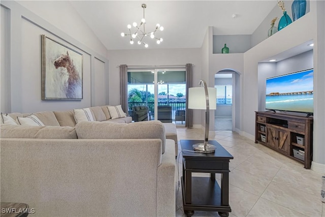 6770 Huntington Lakes Cir Unit 203, Naples, FL 34119 - living room with lofted ceiling, a chandelier, arched walkways, and light tile patterned flooring