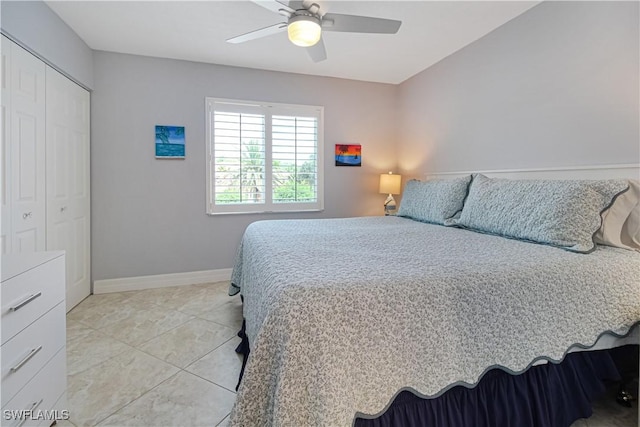 6770 Huntington Lakes Cir Unit 203, Naples, FL 34119 - bedroom with light tile patterned floors, a closet, and a ceiling fan