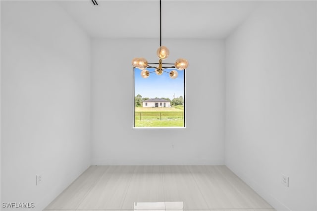 542 Raintree St E, Lehigh Acres, FL 33974 - empty room featuring a chandelier