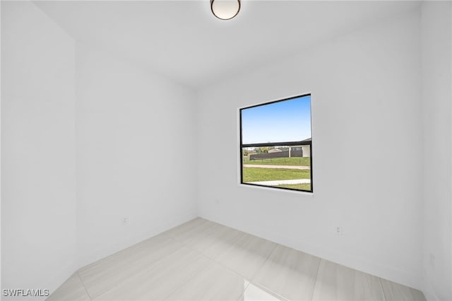 542 Raintree St E, Lehigh Acres, FL 33974 - spare room featuring baseboards