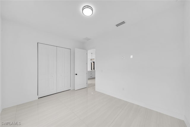 542 Raintree St E, Lehigh Acres, FL 33974 - unfurnished bedroom featuring a closet