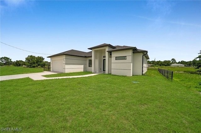 542 Raintree St E, Lehigh Acres, FL 33974 - view of front facade with driveway, stucco siding, and a garage