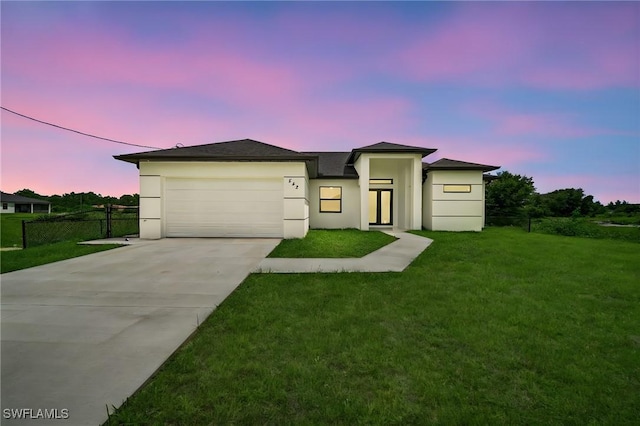 542 Raintree St E, Lehigh Acres, FL 33974 - view of front of house featuring driveway, stucco siding, and an attached garage