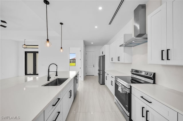 542 Raintree St E, Lehigh Acres, FL 33974 - kitchen featuring stainless steel appliances, wall chimney exhaust hood, light countertops, white cabinetry, and pendant lighting