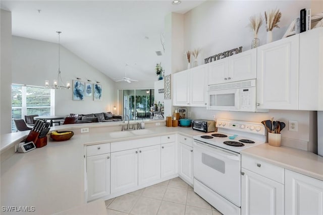 5040 Cedar Springs Dr Unit 201, Naples, FL 34110 - kitchen featuring white appliances, light countertops, a chandelier, vaulted ceiling, and white cabinetry