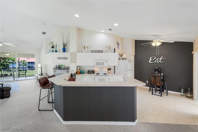 5040 Cedar Springs Dr Unit 201, Naples, FL 34110 - kitchen featuring white appliances, a ceiling fan, high vaulted ceiling, a peninsula, and white cabinets