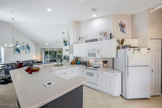 5040 Cedar Springs Dr Unit 201, Naples, FL 34110 - kitchen with white appliances, a peninsula, white cabinetry, light countertops, and light tile patterned floors