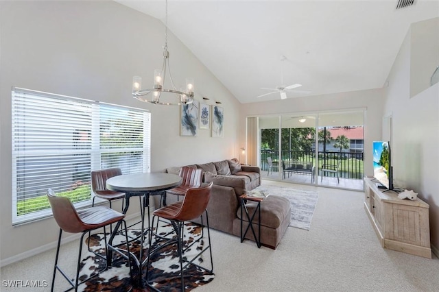 5040 Cedar Springs Dr Unit 201, Naples, FL 34110 - carpeted dining room featuring high vaulted ceiling, a ceiling fan, a chandelier, and healthy amount of natural light