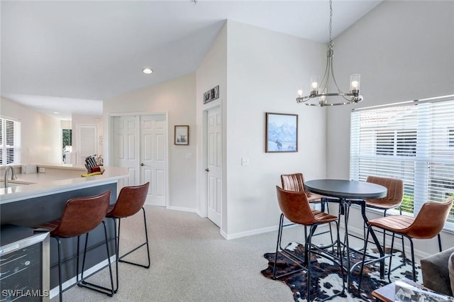 5040 Cedar Springs Dr Unit 201, Naples, FL 34110 - dining space with vaulted ceiling, light colored carpet, a chandelier, and recessed lighting