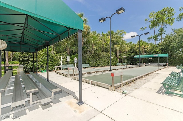 5040 Cedar Springs Dr Unit 201, Naples, FL 34110 - view of property's community featuring a bocce ball area and view of wooded area