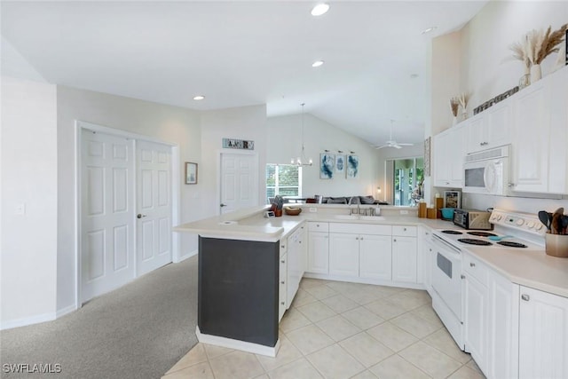 5040 Cedar Springs Dr Unit 201, Naples, FL 34110 - kitchen featuring white appliances, a peninsula, light countertops, open floor plan, and white cabinets