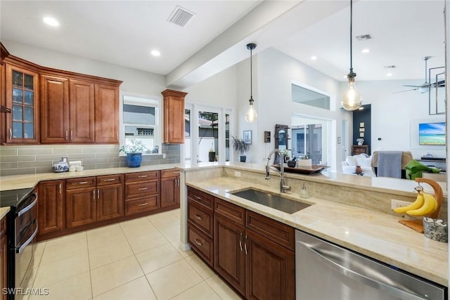 4333 Mistlethrush Ln, Naples, FL 34119 - kitchen featuring stainless steel appliances, backsplash, pendant lighting, light stone counters, and vaulted ceiling