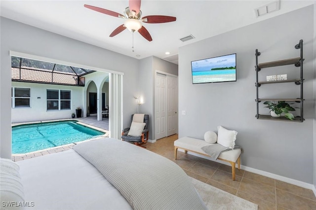 4333 Mistlethrush Ln, Naples, FL 34119 - bedroom featuring arched walkways, tile patterned floors, a closet, and ceiling fan
