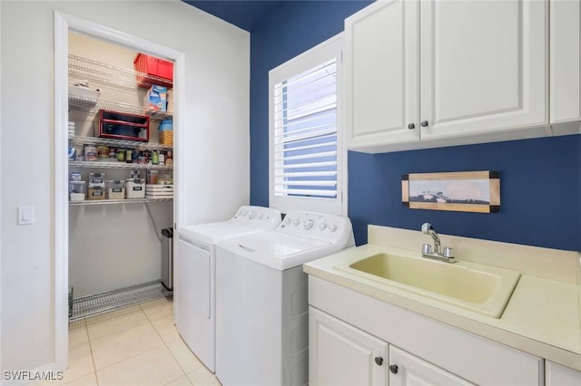 4333 Mistlethrush Ln, Naples, FL 34119 - laundry room featuring washing machine and clothes dryer, cabinet space, and light tile patterned flooring