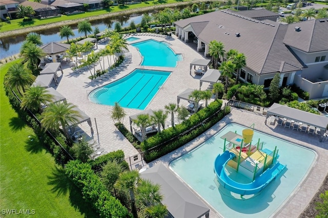 4406 Caldera Cir, Naples, FL 34119 - community pool featuring a water slide, a water play area, and a patio