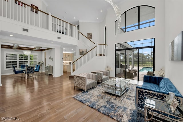 4406 Caldera Cir, Naples, FL 34119 - living area with a high ceiling, stairs, wood finished floors, healthy amount of natural light, and recessed lighting