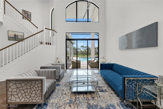 4406 Caldera Cir, Naples, FL 34119 - living room with a high ceiling, stairway, and wood finished floors