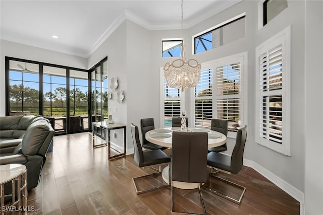 4406 Caldera Cir, Naples, FL 34119 - dining room featuring a chandelier, ornamental molding, wood finished floors, recessed lighting, and a high ceiling
