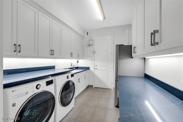 4406 Caldera Cir, Naples, FL 34119 - laundry area with washer and clothes dryer, cabinet space, and light tile patterned floors