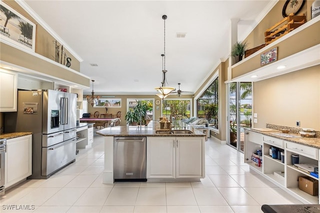 11840 Longshore Way W, Naples, FL 34119 - kitchen with appliances with stainless steel finishes, stone counters, decorative light fixtures, light tile patterned floors, and a center island