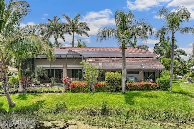 11840 Longshore Way W, Naples, FL 34119 - rear view of property with a tile roof, a lanai, stucco siding, and a yard