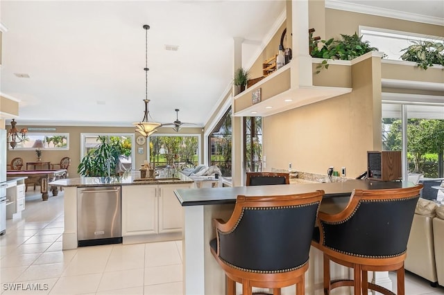 11840 Longshore Way W, Naples, FL 34119 - kitchen with stainless steel dishwasher, a ceiling fan, light tile patterned flooring, crown molding, and pendant lighting