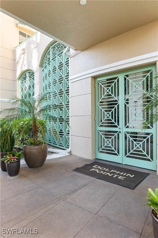 4137 Bay Beach Ln Unit 5P2, Fort Myers Beach, FL 33931 - doorway to property featuring stucco siding