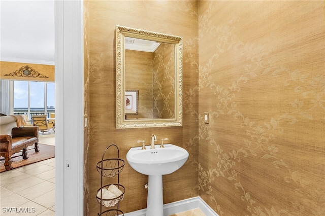 4137 Bay Beach Ln Unit 5P2, Fort Myers Beach, FL 33931 - bathroom with crown molding, tile patterned floors, and wallpapered walls