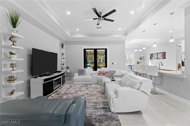 2642 10th Ave NE, Naples, FL 34120 - living area with a tray ceiling, ceiling fan, light tile patterned floors, a chandelier, and recessed lighting